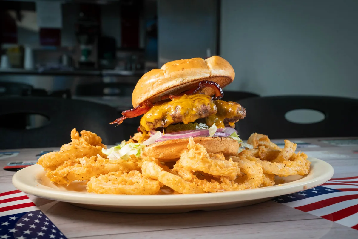 Bacon cheeseburger served with onion rings