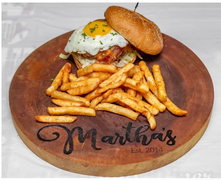 Diner burger served with seasoned fries on Martha’s board
