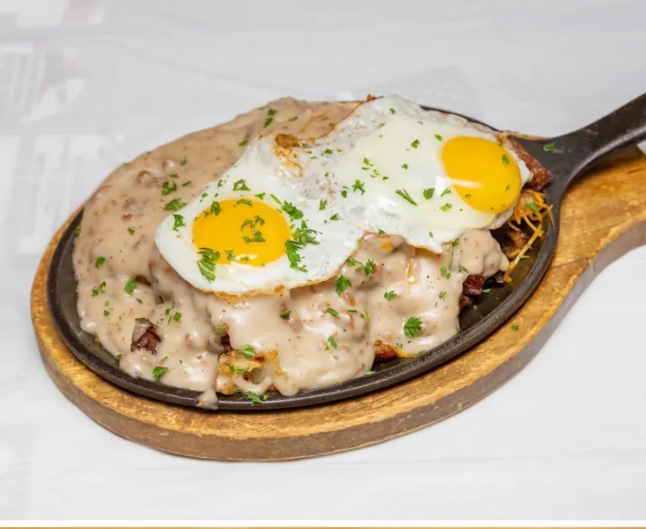 Breakfast skillet covered with country gravy and eggs
