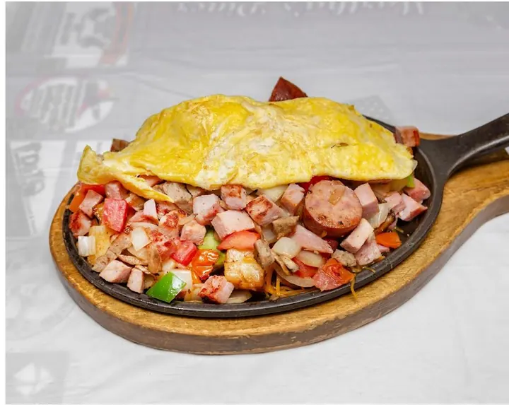 Breakfast skillet topped with an omelet