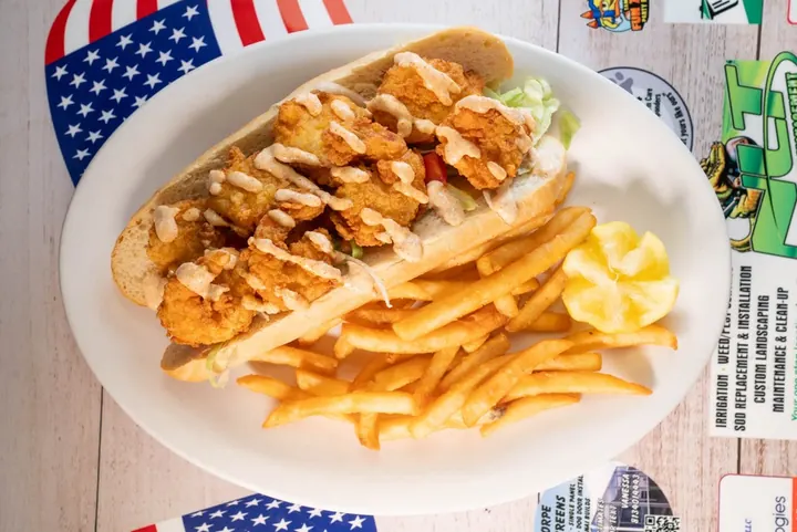 Crispy seafood sandwich served with fries